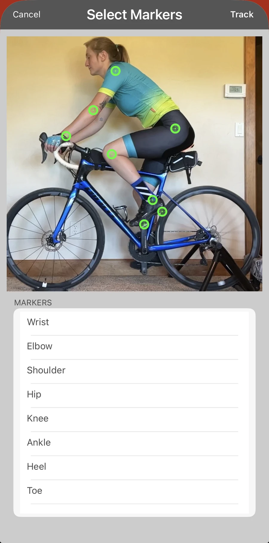 The Bike Fast Fit Pro Select Markers screen: eight tracking points placed by hand on a rider, with the wrist, elbow, shoulder, hip, knee, ankle, heel and toe list beside them